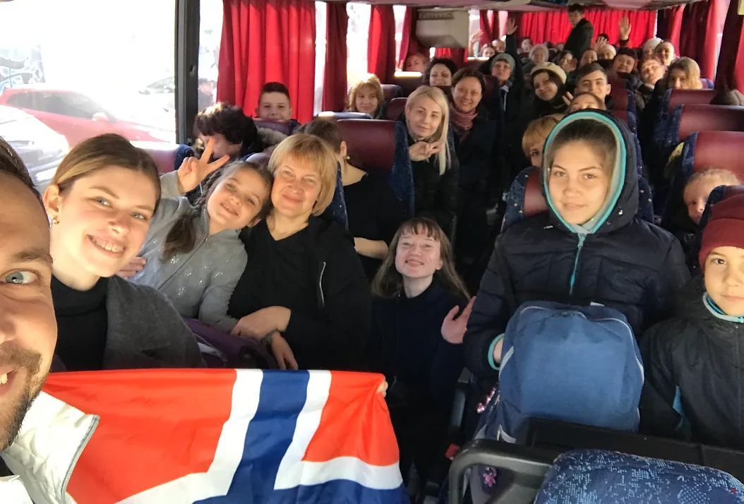 Happy people sitting inside a bus.