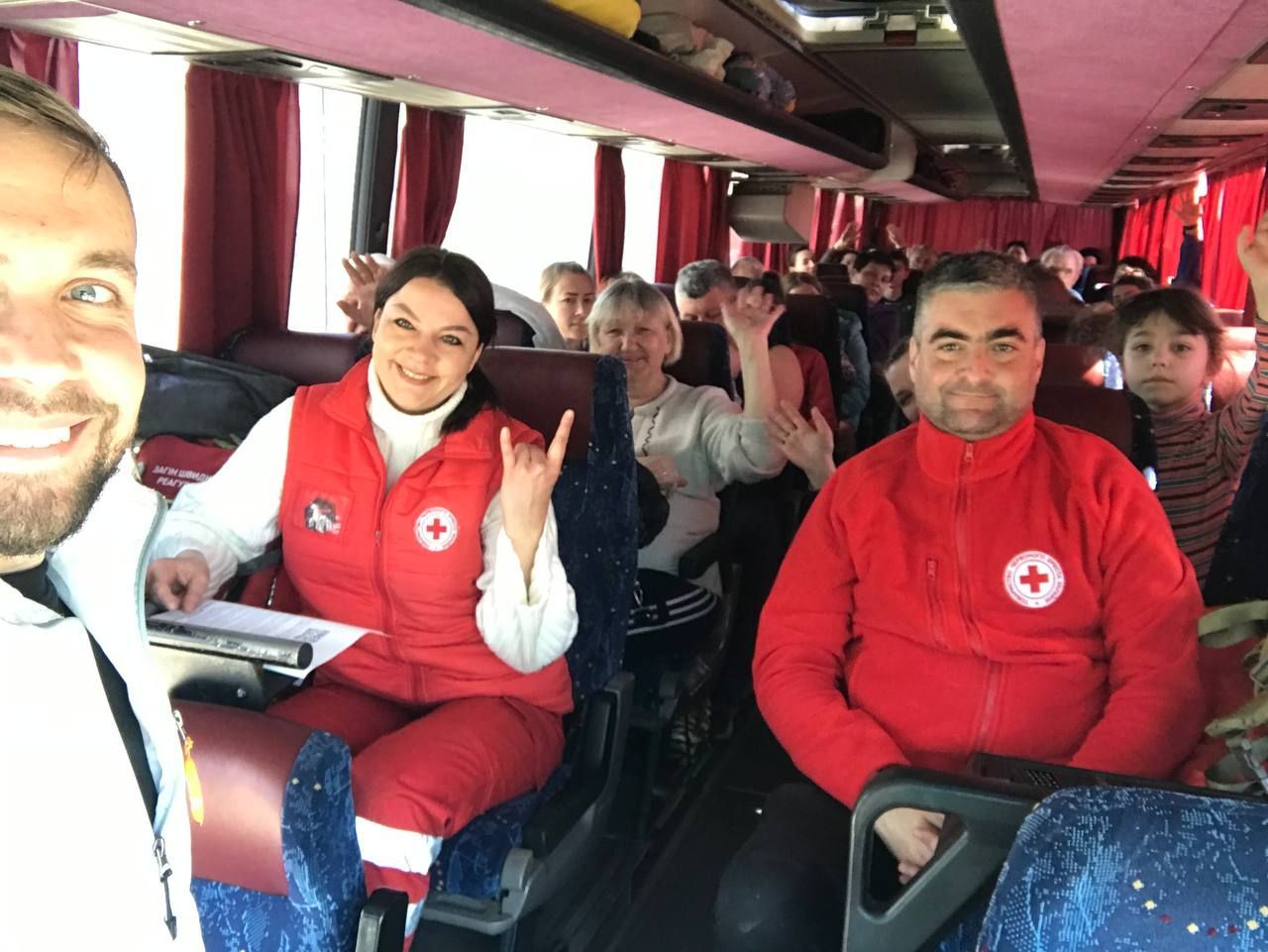 Paramedics and passengers inside a bus.