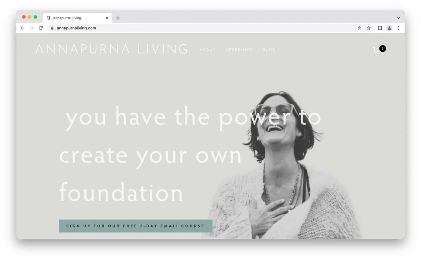 Screenshot from Annapurna Living, woman laughing with grey background