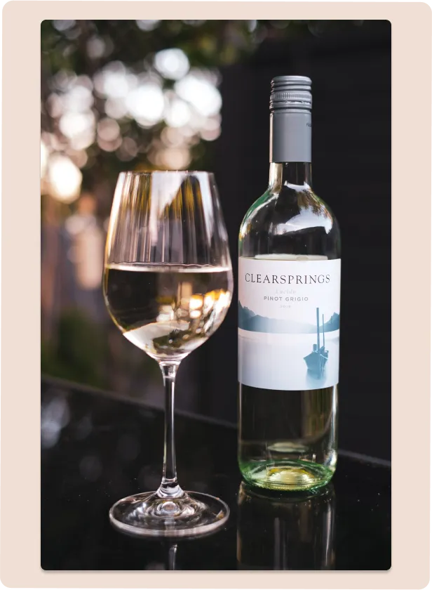 A glass of wine on a dark table