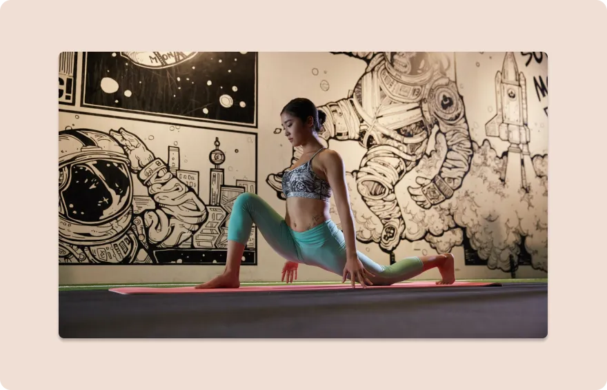 woman doing yoga pose in front of graffiti wall